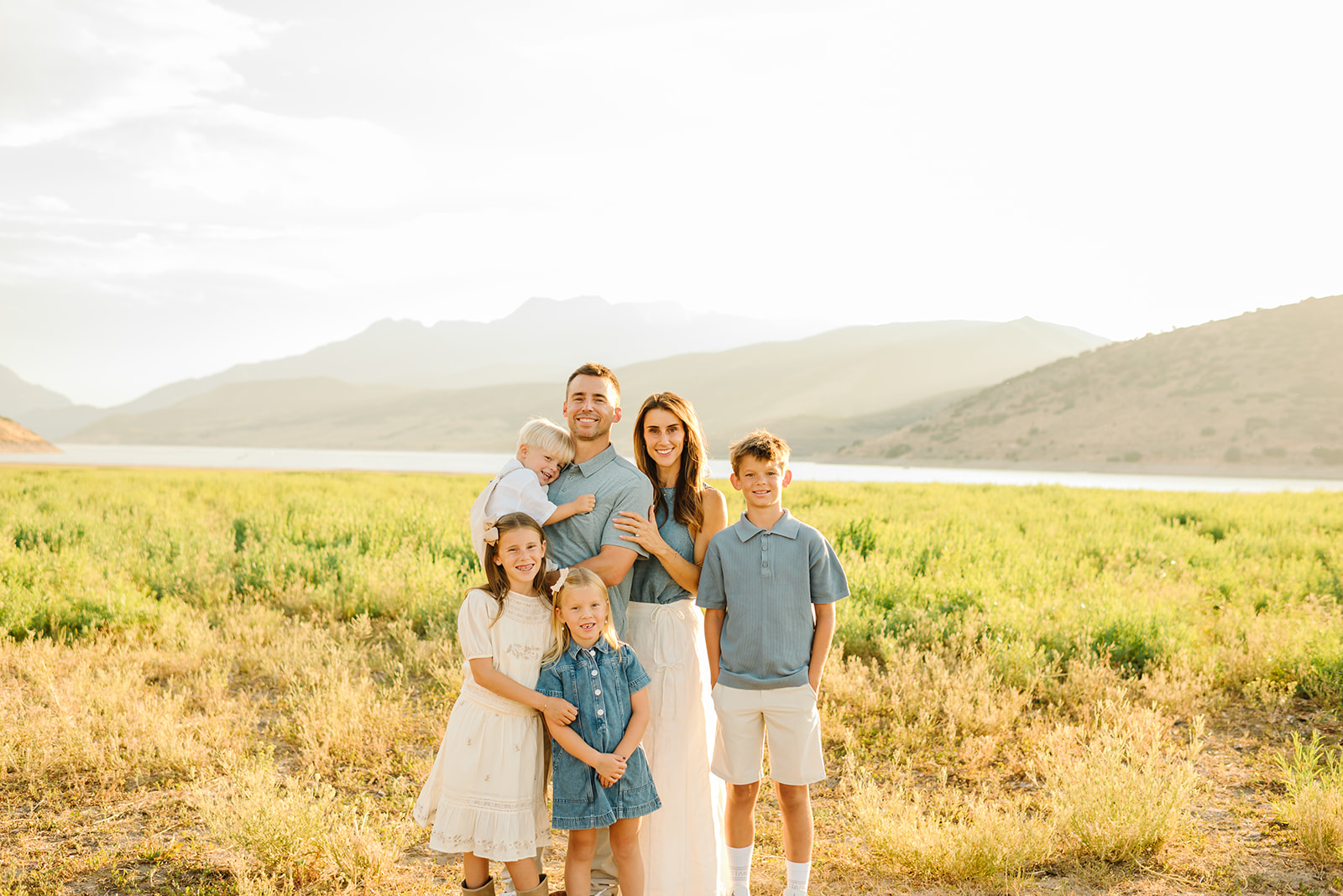 The Hunsaker family smiling outdoors in Lehi, Utah